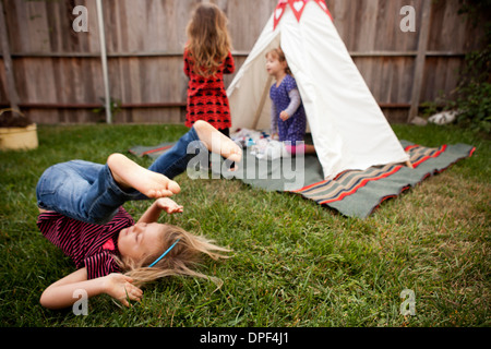 Three young girls playing in garden Stock Photo