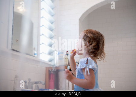 Female toddler cleaning teeth Stock Photo