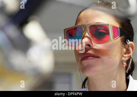 Close up of female scientist wearing red protective glasses Stock Photo