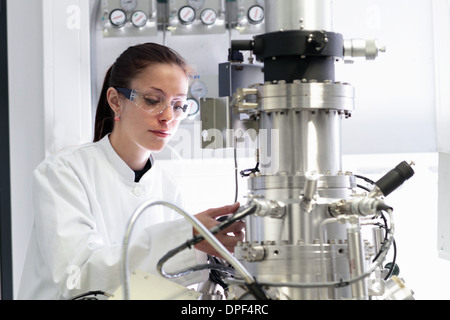 Female scientist operating scientific equipment in laboratory