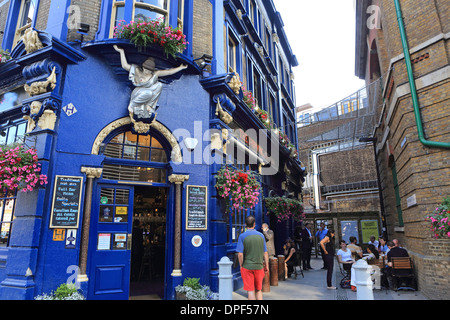 The Shipwright's Arms pub near London Bridge station, with a train passing behind, on Tooley Street, in Southwark, London, UK Stock Photo