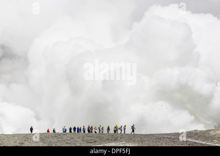 Visitors watching mud being ejected from an active andesite stratovolcano on White Island, North Island, New Zealand Stock Photo