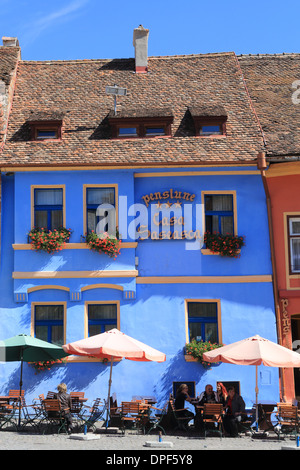 Cafes and pensions on the main square in Sighisoara, the fortified medieval town, in Transylvania, Romania Stock Photo
