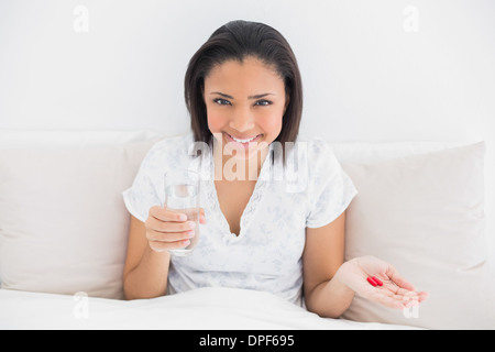 Content young dark haired model taking medication Stock Photo