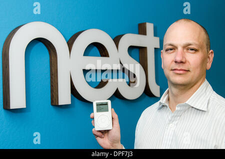 At Apple, Tony Fadell helped develop both iPod and iPhone. He co-found smart appliance maker Nest, which was acquired by Google in January 2014. In an unusual photo, Fadell is seen here in 2012 at Nest HQ in Palo Alto, CA, showing the original iPod. Stock Photo