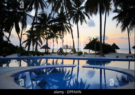 Reflection of palm trees in swimming pool at sunrise, Bwejuu Beach, Zanzibar, Tanzania, Indian Ocean, East Africa, Africa Stock Photo