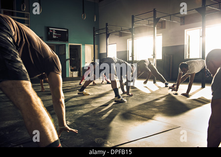 Fitness group training together in gym