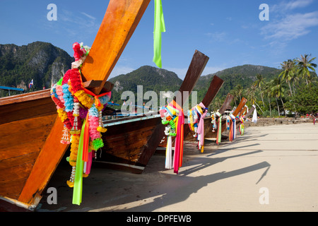 Garlands decorating long-tail boats on beach, Koh Phi Phi, Krabi Province, Thailand, Southeast Asia Stock Photo