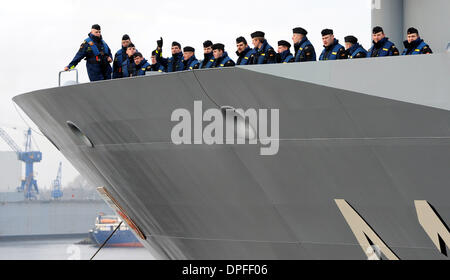 Wilhelmshaven, Germany. 14th Jan, 2014. The new supply ship (EGV) Bonn leaves the German navy base Wilhelmshaven and starts its first big tour in Wilhelmshaven, Germany, 14 January 2014. Crew members stand on deck. The systems of the new supply ship of the German navy will be put on trial in the extreme heat of the Carribean Sea and West Africa as well as the extreme cold of the Polar circle. The suplly hsip will return to its naval base in May. Photo: INGO WAGNER/dpa/Alamy Live News Stock Photo