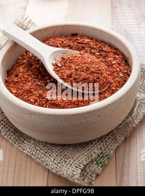 ground red cayenne pepper in wooden bowl, close up Stock Photo
