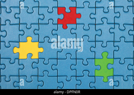 Jigsaw Puzzle with missing pieces in three different colors Stock Photo
