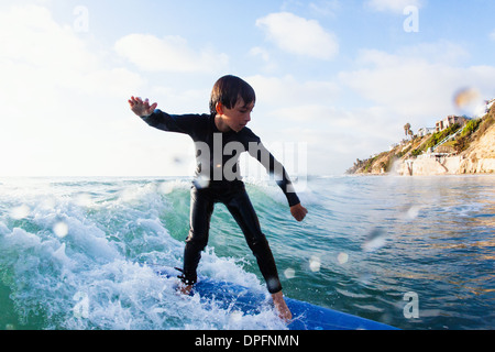 Young boy surfing wave, Encinitas, California, USA Stock Photo
