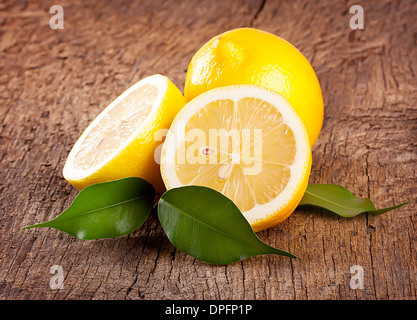 Ripe bright lemons on a wooden background Stock Photo