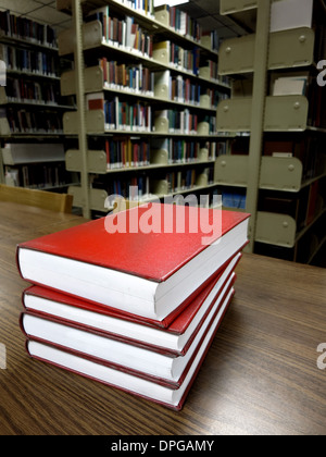 Stack of old books on a desk or table in a library
