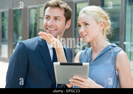 Real estate agent with digital tablet showing property to potential buyer Stock Photo