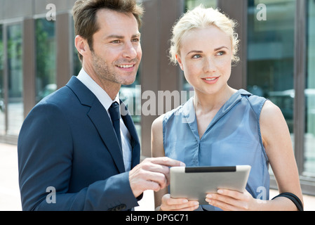 Real estate agent with digital tablet showing property to potential buyer Stock Photo