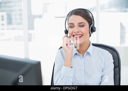 Attractive classy brown haired operator answering a call Stock Photo