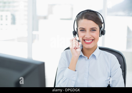 Beautiful classy brown haired operator answering a call Stock Photo