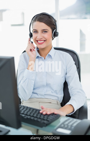 Pretty classy brown haired operator answering a call Stock Photo