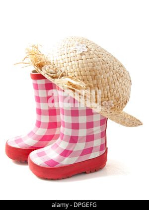 Rubber boots with straw head isolated over wiite Stock Photo