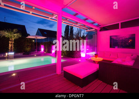 Private House at night with light show, conservatory, lounge, pool and terrace, Germany, Europe - August 2013 Stock Photo
