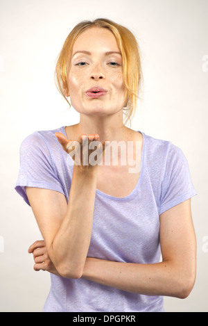 Young woman blowing a kiss, portrait Stock Photo