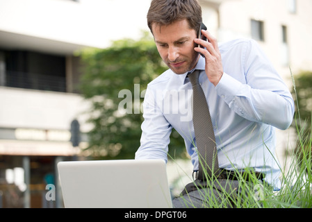Businessman working outdoors Stock Photo