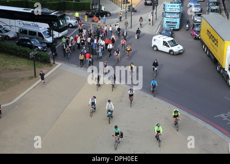 Cyclists and pedestrians cross the road at Hyde Park Corner in rush hour, in London, England Stock Photo