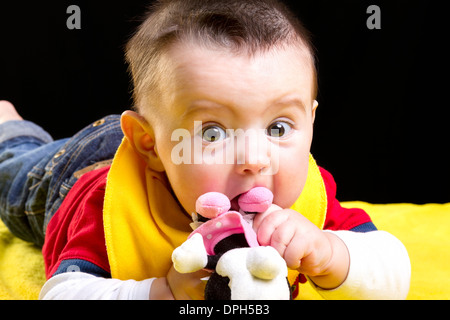 Baby boy on yellow blanket Stock Photo