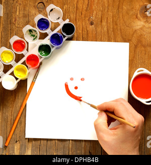 painting set - brushes, paints (gouache) on old wooden table Stock Photo