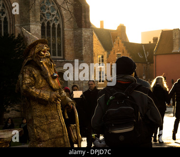human gold wizard living statue tourist interacting with crowed tourists Stock Photo