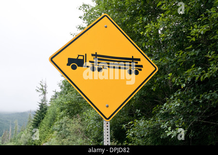 A sign depicting a logging truck and logging activities on a highway near Port Hardy, on Vancouver Island, British Columbia, Canada. Stock Photo