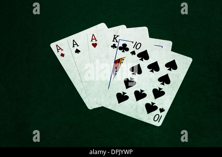 Poker Hands - Three Of A Kind 4. Closeup view of five playing cards forming the poker three of a kind hand. Stock Photo