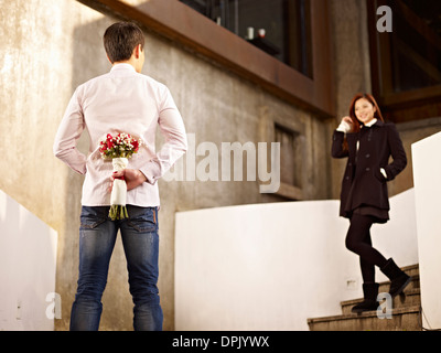 young man waiting for girlfriend with flowers Stock Photo