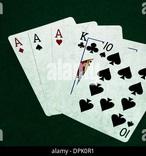 Poker Hands - Three Of A Kind 4. Closeup view of five playing cards forming the poker three of a kind hand Stock Photo