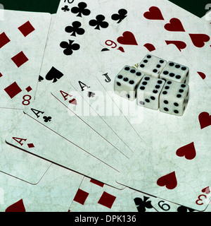 Good Luck To You 3. Closeup view of playing cards and five dices with six pips atop Stock Photo