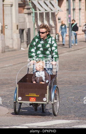 Denmark, Copenhagen, father transporting child on a Christiania bike Stock Photo