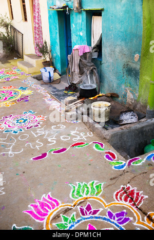 Rural Indian village street covered with Rangoli festival coloured powder designs at Sankranti. Andhra Pradesh, India Stock Photo