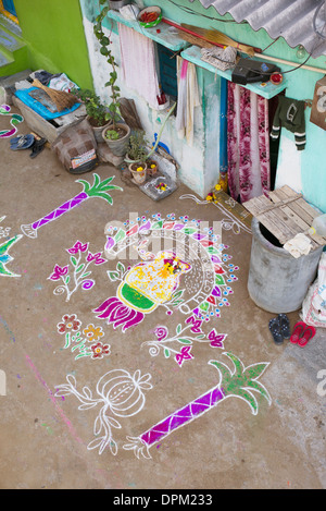 Rural Indian village street covered with Rangoli festival coloured powder designs at Sankranti. Andhra Pradesh, India Stock Photo