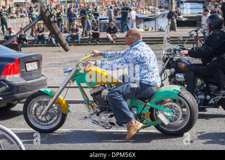 Middle-aged man riding Harley Davidson syle motorbike at Nyhavn, Copenhagen, Denmark Stock Photo