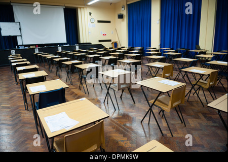 Rows of empty desks ready for Welsh GCSE school pupils to sit their exams in a school hall, Wales UK Stock Photo