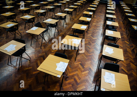 Rows of empty desks ready for Welsh GCSE school pupils to sit their exams in a school hall, Wales UK Stock Photo