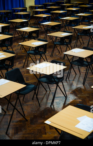 Rows of empty desks ready for Welsh GCSE school pupils to sit their exams in a school hall, Wales UK Stock Photo