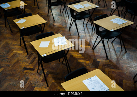 Rows of empty desks ready for Welsh GCSE school pupils to sit their exams in a school hall, Wales UK Stock Photo