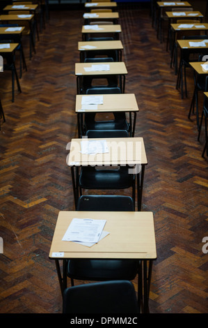 Rows of empty desks ready for Welsh GCSE school pupils to sit their exams in a school hall, Wales UK Stock Photo