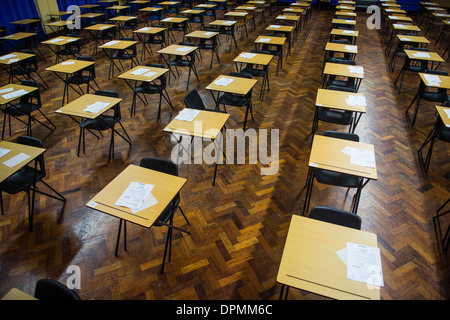 Rows of empty desks ready for Welsh GCSE school pupils to sit their exams in a school hall, Wales UK Stock Photo