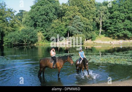 Two horse riders on Keston Pond, Bromley, Kent, England, UK Stock Photo
