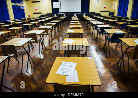 Rows of empty desks ready for Welsh GCSE school pupils to sit their exams in a school hall, Wales UK Stock Photo