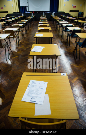 Rows of empty desks ready for Welsh GCSE school pupils to sit their exams in a school hall, Wales UK Stock Photo