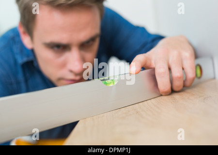 Young handyman using a spirit level Stock Photo
